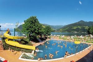 a large swimming pool with people in the water at Studio-Apartment Areit in Zell am See