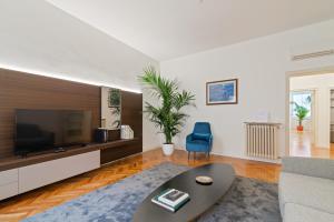 - un salon avec un canapé et une télévision dans l'établissement San Fermo Luxury Apartment, à Padoue