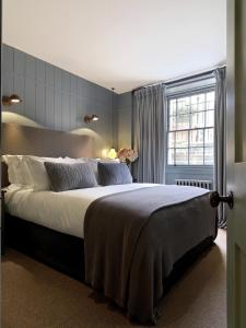 a bedroom with a large bed and a window at No131 The Promenade in Cheltenham