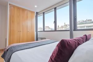 a bedroom with a bed and some windows at Sibs Bcn- Universitat- Cosmopolitan LGTB Cozy in Barcelona