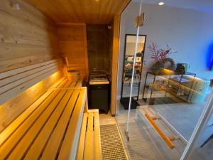 a sauna with a wooden bench in a room at Van der Valk Hotel Sassenheim - Leiden in Sassenheim