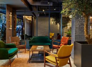 
a living room filled with chairs and tables at Hotel Indigo Madrid - Princesa, an IHG Hotel in Madrid
