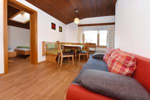 a living room with a couch and a table at Haus Bahl in Schruns-Tschagguns