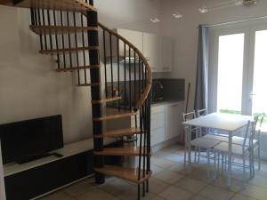 a wooden spiral staircase in a kitchen with a table at Peri village in Peri