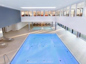 a large swimming pool in a building at DORMERO Strandhotel Rügen in Binz