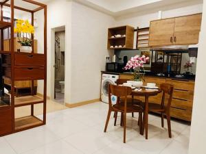 a kitchen with a wooden table and chairs at Eyu@Timurbay Seaview Residence in Kuantan