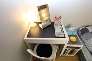 a desk with a lamp and a chair in a room at The Viking Country Club in Hjalteyri