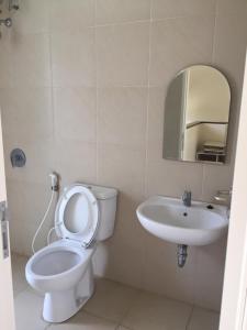 a bathroom with a toilet and a sink at House at Taman Dayu in Pasuruan +40 photos