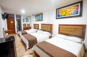 Ένα ή περισσότερα κρεβάτια σε δωμάτιο στο D´Milez Hotel +33 φωτογραφίες