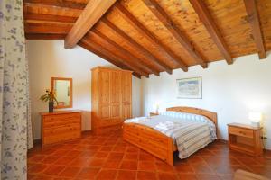 a bedroom with a bed and a wooden ceiling at Agriturismo La Filanda in Manerba del Garda