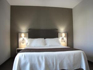 Posteľ alebo postele v izbe v ubytovaní Hotel Ton
