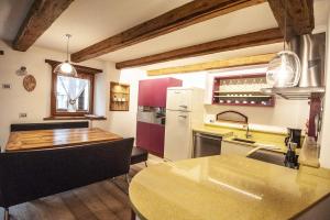 a kitchen with a sink and a counter top at Chalet Tobià in Canazei