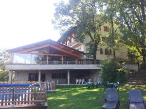 a large building with a playground in the yard at Hostal Pedraforca in Saldés