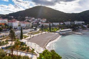 a view of a city with a beach and a mountain at Dubrovnik Luxury Residence – L’Orangerie in Dubrovnik