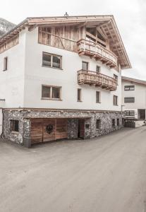 a large white building with a balcony at Chalet Nr.121 in Pfunds