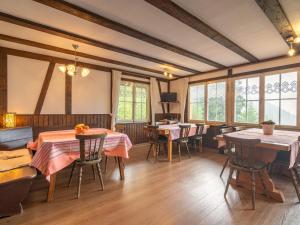 a dining room with tables and chairs and windows at Ferienwohnung mit Talblick in Todtmoos in Todtmoos +32 photos