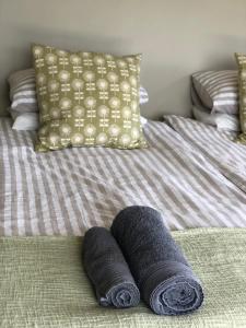 - un lit avec 2 serviettes pliantes dans l'établissement Caledon Country House, à Clarens
