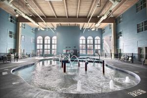 a pool of water with fountains in a building at Holiday Inn Express Hotel & Suites Milwaukee Airport by IHG in Milwaukee