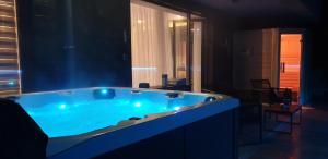 a large blue tub in a room at Mariah Spa Deluxe Apartment in SILVER MOUNTAIN in Poiana Brasov