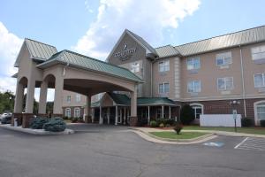 a hotel with a parking lot in front of it at Country Inn & Suites by Radisson, Emporia, VA in Emporia