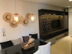 a living room with a couch and a wine cellar at Apartamento Vêneto in Canela