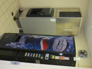 a soda machine with a football painted on it at Super 8 by Wyndham Crossville TN in Crossville