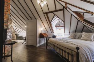 a bedroom with a large bed in an attic at Double Oaks Bed & Breakfast in Greensboro