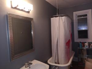 a bathroom with a sink and a shower and a toilet at Room with King Bed in Shared 3 Bedroom Downtown in Montréal