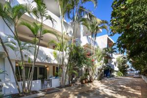 a building with palm trees in front of it at Villa Dorado - Duplex in Sayulita