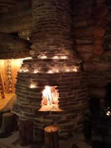 a stone fireplace with lights in a room at Ruka Aava in Ruka