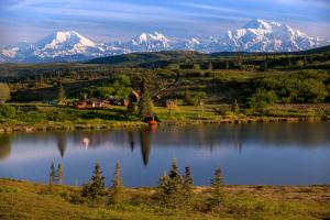 a view of a lake with mountains in the background at Caribou Lodge Alaska in Talkeetna