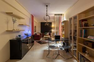 a kitchen and living room with a table and chairs at Volos Center Luxury Home in Volos