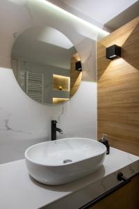 y baño con lavabo blanco y espejo. en Volos Center Luxury Home, en Volos