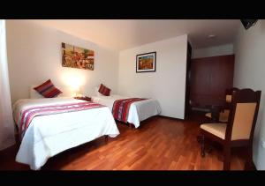 Cama ou camas em um quarto em Hotel Santa Maria