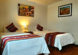 Cama ou camas em um quarto em Hotel Santa Maria