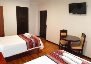 Cama ou camas em um quarto em Hotel Santa Maria