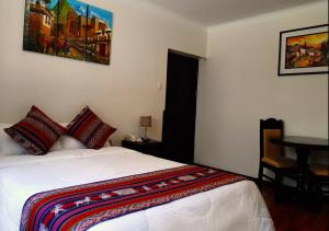 Cama ou camas em um quarto em Hotel Santa Maria