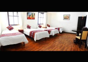 Cama ou camas em um quarto em Hotel Santa Maria
