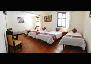 Cama ou camas em um quarto em Hotel Santa Maria