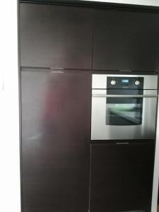 a stainless steel refrigerator and oven in a kitchen at Edificio Yoo in Punta del Este