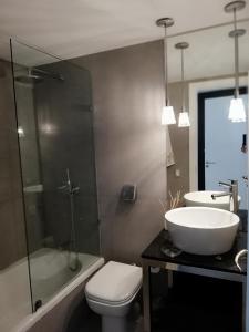 a bathroom with a sink and a toilet and a shower at Edificio Yoo in Punta del Este