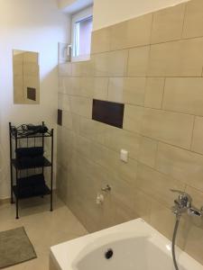 a bathroom with a sink and a bath tub at Budapest Airport , accommodation in Vecsés in Vecsés
