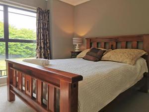 a bedroom with a bed and a large window at Lake Taupo Holiday Home in Taupo