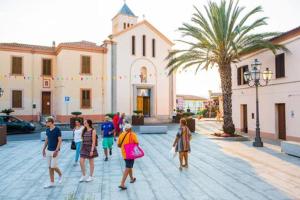 a group of people walking in front of a church at Casa Antony in San Teodoro