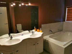 a bathroom with two sinks and a large mirror at Lake Taupo Holiday Home in Taupo