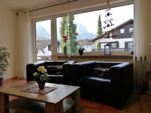 a living room with a couch and a table at Ferienwohnungen Angelika in Garmisch-Partenkirchen