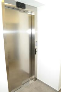 a stainless steel elevator in a building at Riverside Apartman with Free Parking in Győr