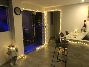 a room with a kitchen with lights and a table at White 11 in Larnaca