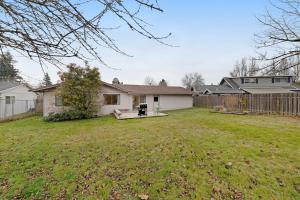 a yard with a house and a fence at Home in the Silicon Forest in Beaverton