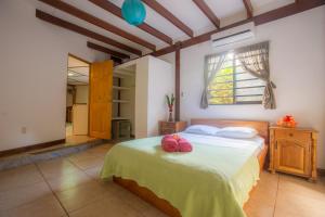 a bedroom with a bed with red towels on it at Casa Margarita in Puerto Viejo +32 photos